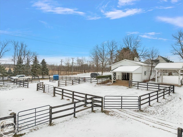 snowy yard featuring a rural view