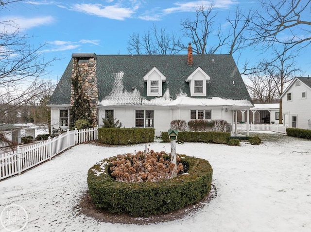 view of snow covered rear of property