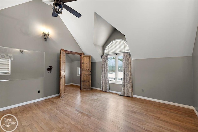 interior space with ceiling fan, light hardwood / wood-style floors, and lofted ceiling