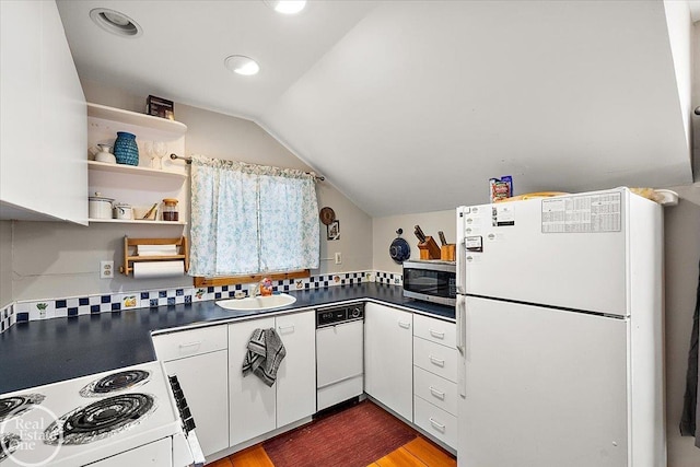 kitchen featuring white cabinetry, sink, tasteful backsplash, lofted ceiling, and white appliances