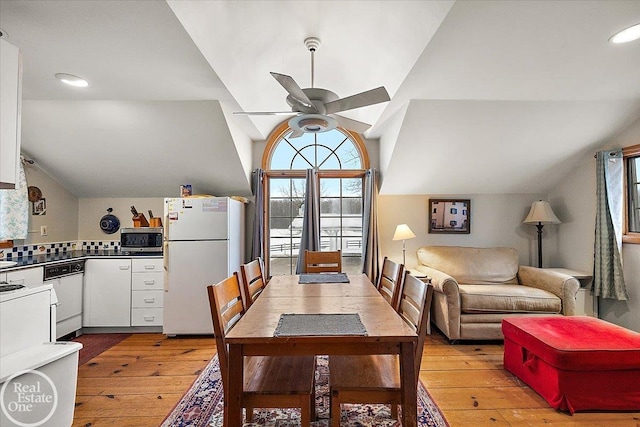 dining area with ceiling fan, light hardwood / wood-style flooring, and lofted ceiling