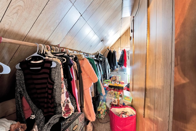 spacious closet with lofted ceiling and carpet