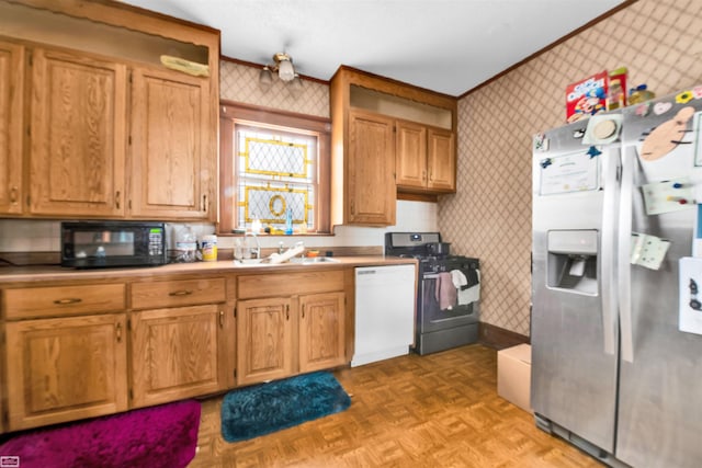 kitchen with light parquet flooring, stainless steel appliances, and sink