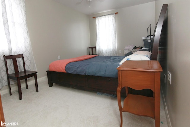 bedroom featuring light colored carpet and ceiling fan