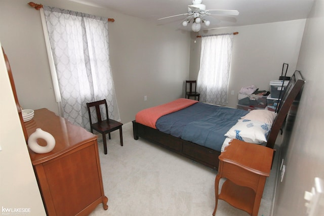 bedroom featuring light carpet and ceiling fan