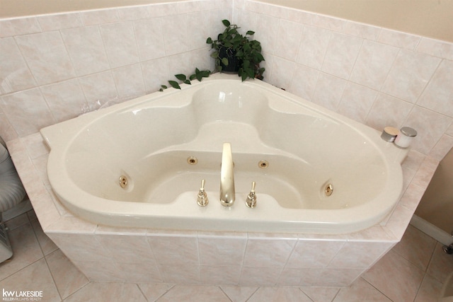 bathroom featuring tile patterned flooring and tiled bath