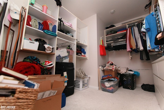 spacious closet featuring light carpet