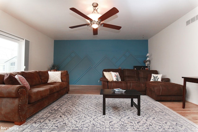 living room with hardwood / wood-style flooring and ceiling fan