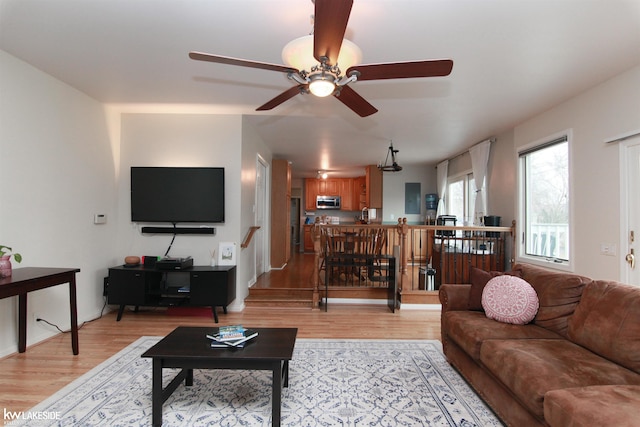 living room with ceiling fan and light wood-type flooring