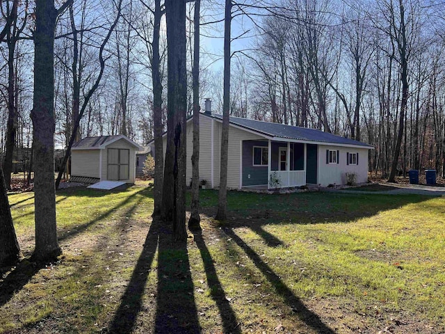 ranch-style home featuring a storage unit and a front yard