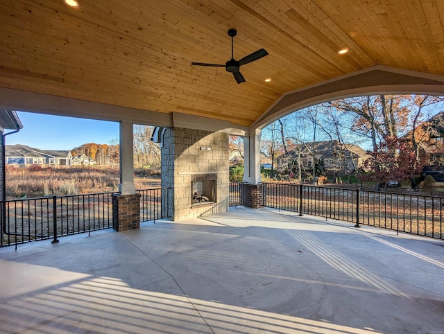 view of patio / terrace with an outdoor stone fireplace and ceiling fan