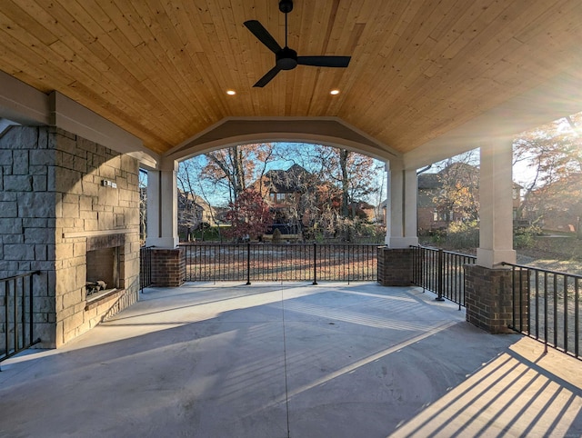 view of patio / terrace with ceiling fan and an outdoor stone fireplace