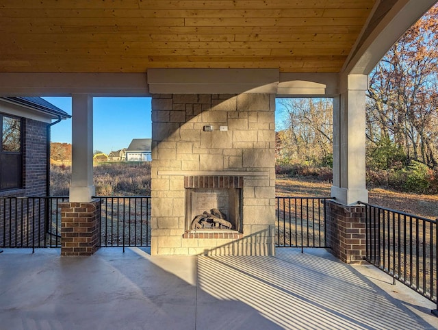 view of patio / terrace featuring an outdoor stone fireplace