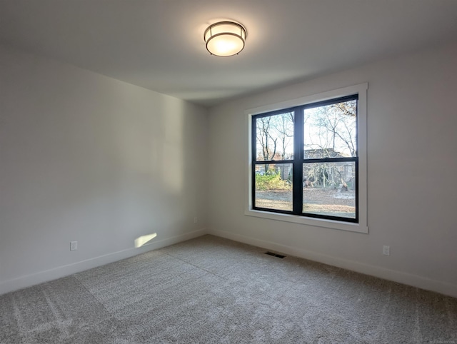 unfurnished room featuring carpet