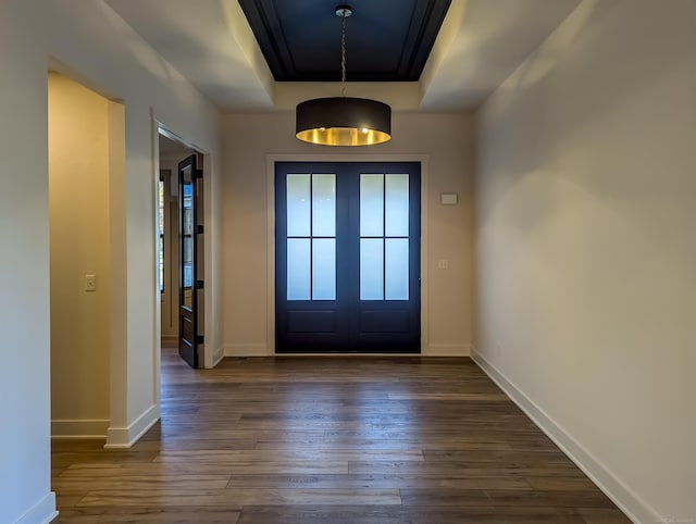 entrance foyer with french doors, dark wood-type flooring, and a tray ceiling