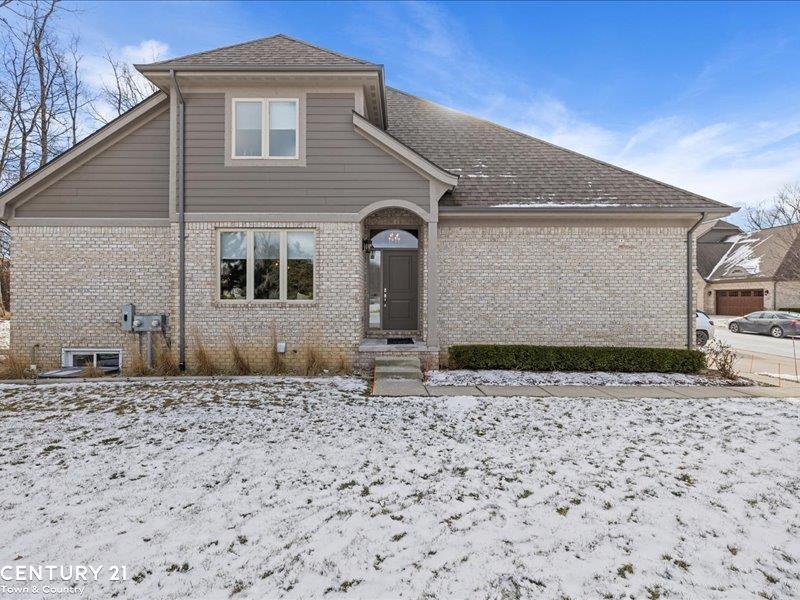 view of snow covered rear of property