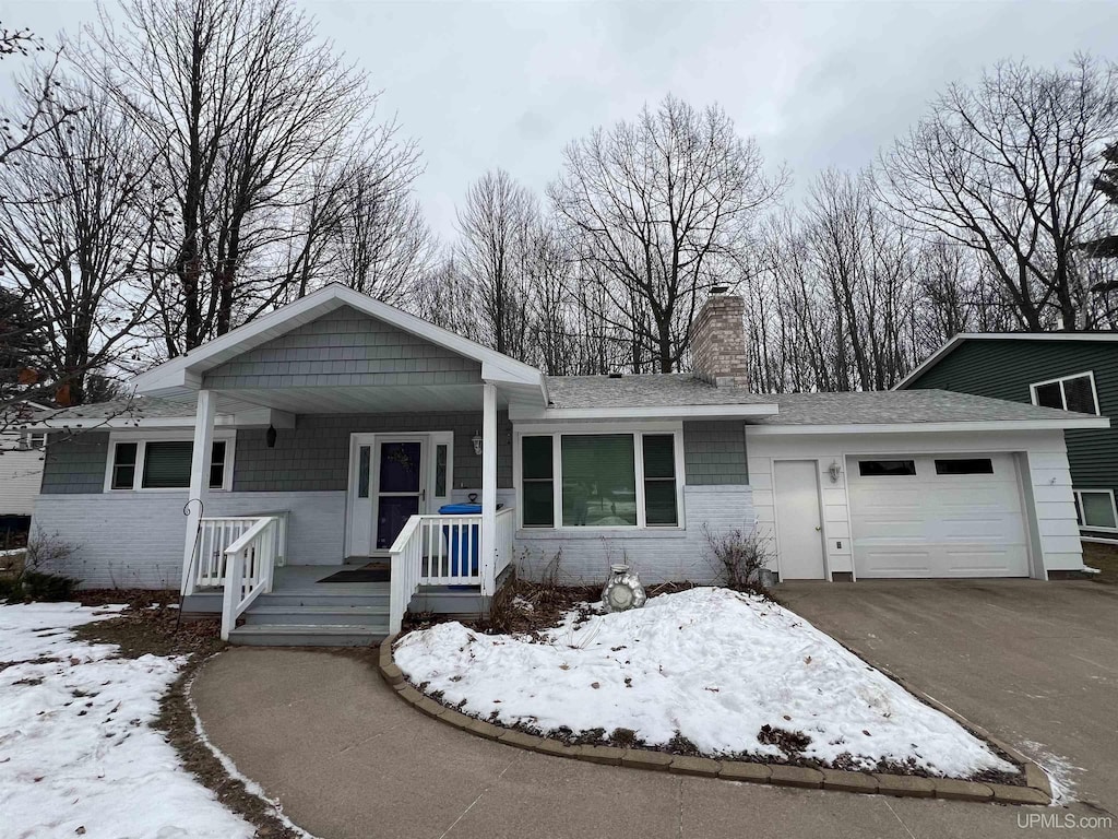 view of front of property featuring a porch and a garage