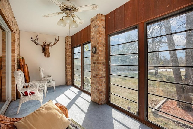 sunroom / solarium with ceiling fan and a wealth of natural light