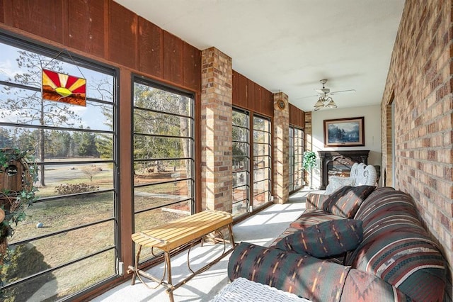 sunroom featuring plenty of natural light and ceiling fan