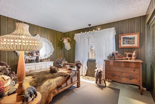 bedroom featuring carpet flooring and a textured ceiling