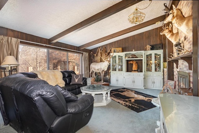 carpeted living room with wood walls, a fireplace, lofted ceiling with beams, and a textured ceiling