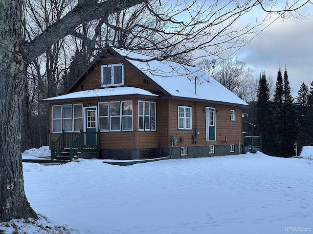 view of snow covered back of property