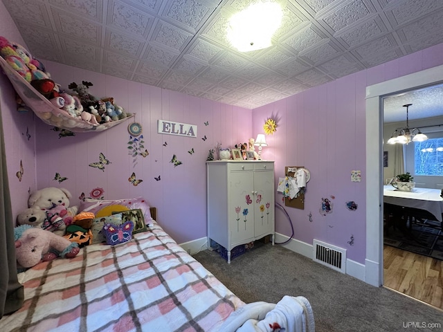 bedroom featuring carpet floors and a notable chandelier