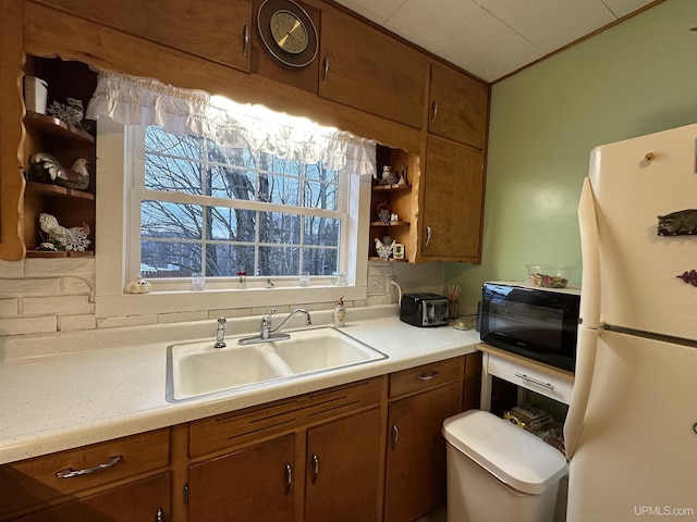 kitchen featuring white fridge and sink