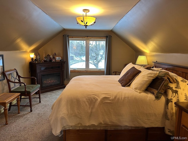 carpeted bedroom featuring vaulted ceiling