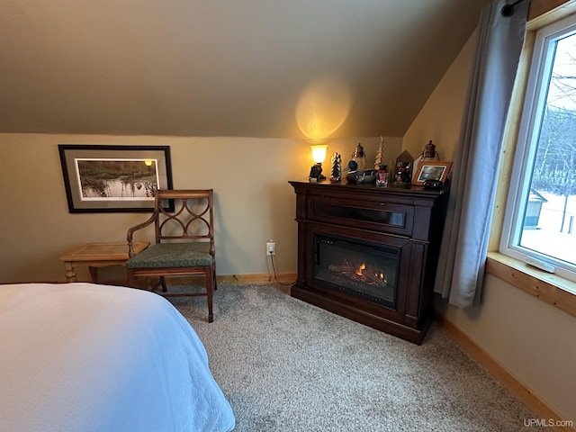 carpeted bedroom with lofted ceiling