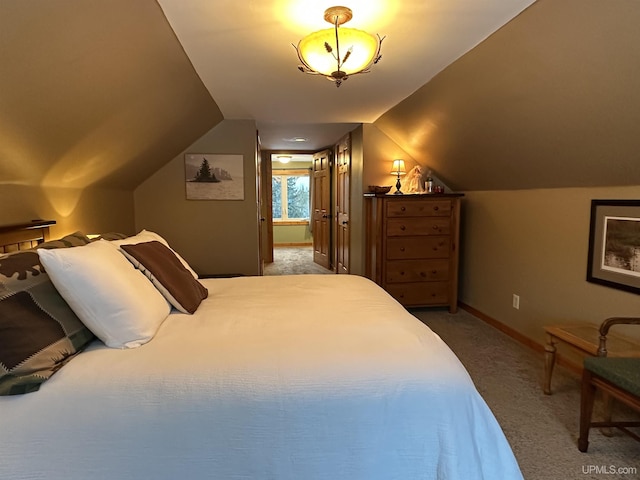 bedroom featuring carpet flooring and lofted ceiling