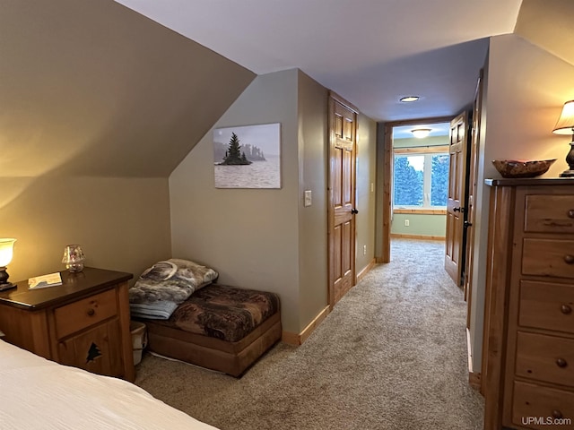 carpeted bedroom with lofted ceiling