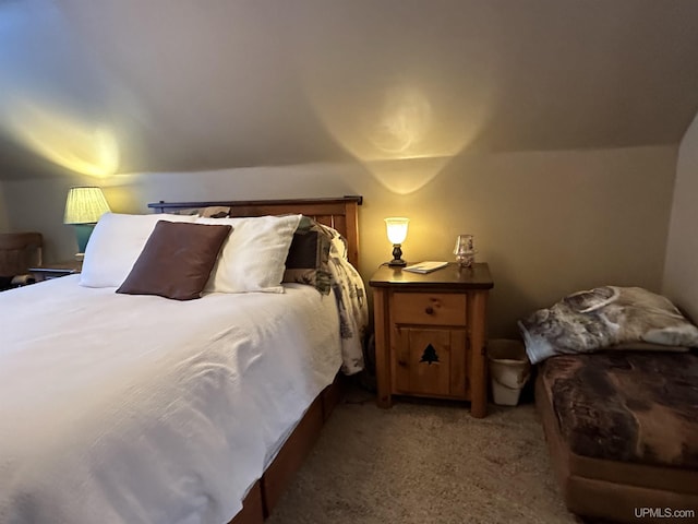 carpeted bedroom with lofted ceiling