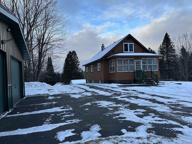 snow covered property featuring a garage