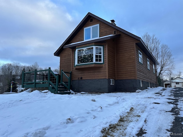 view of snow covered exterior featuring a deck