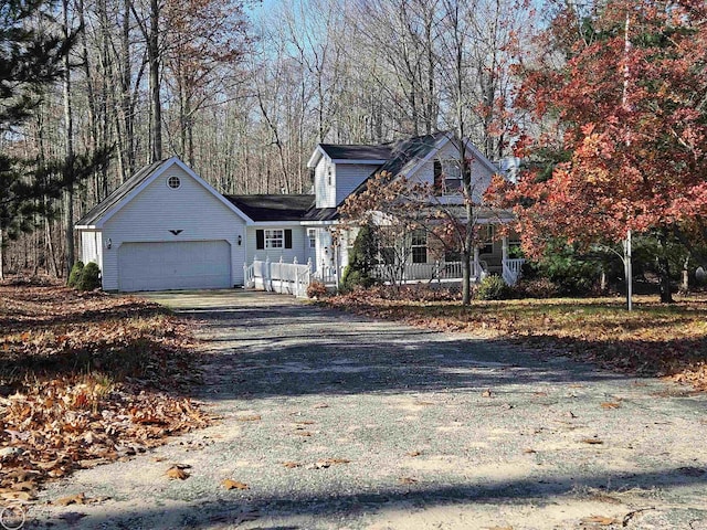 view of front facade featuring covered porch and a garage