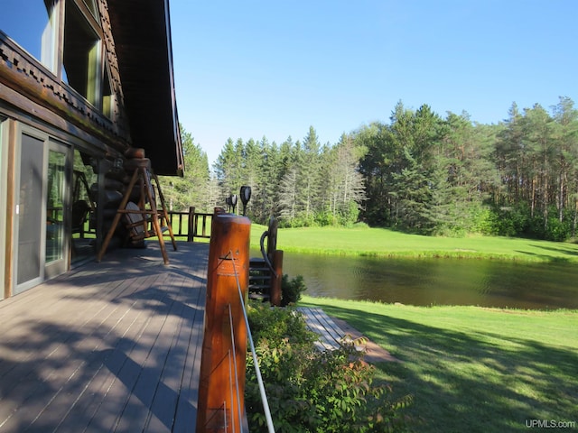 wooden terrace with a lawn and a water view