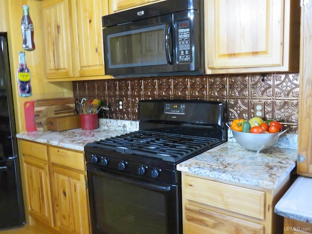 kitchen featuring light brown cabinetry, tasteful backsplash, light stone counters, and black appliances