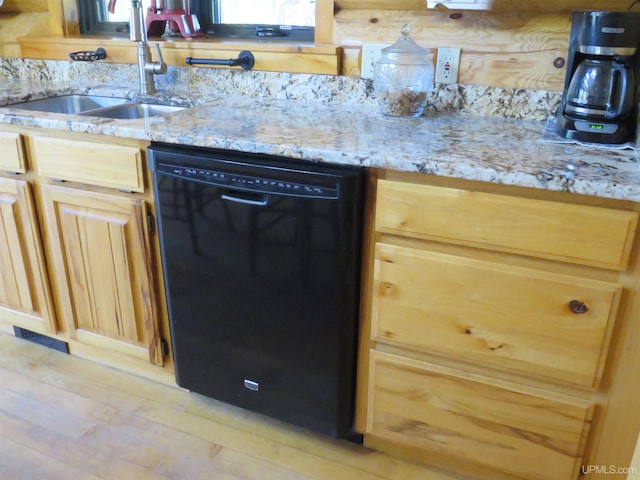 kitchen featuring light stone counters, sink, light wood-type flooring, and black dishwasher