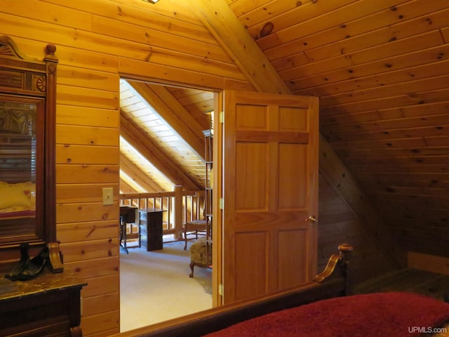 bedroom with lofted ceiling with beams, wood ceiling, carpet floors, and wooden walls