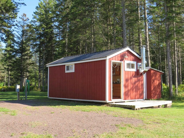 view of outbuilding with a yard