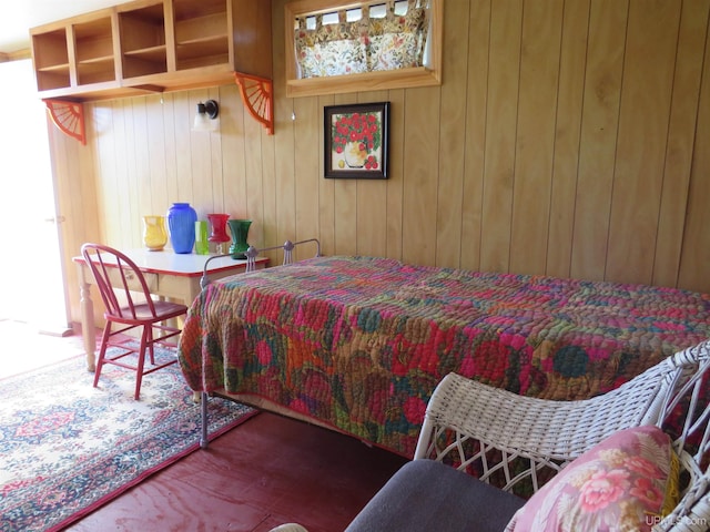 bedroom featuring wooden walls