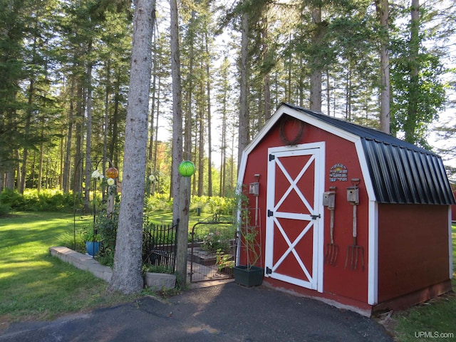 view of outbuilding with a lawn