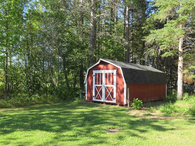 view of outdoor structure featuring a lawn