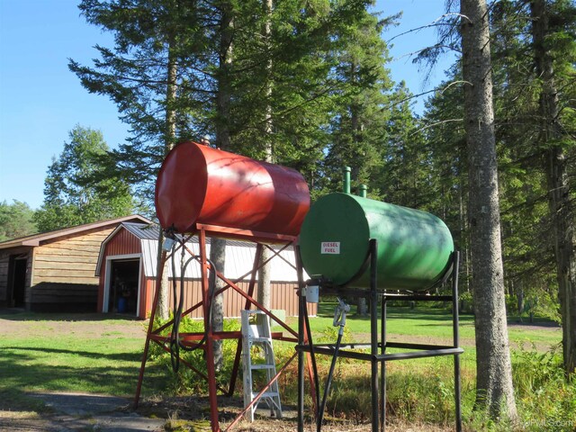 view of play area with an outdoor structure and a lawn