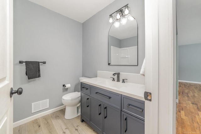 bathroom featuring hardwood / wood-style floors, vanity, and toilet