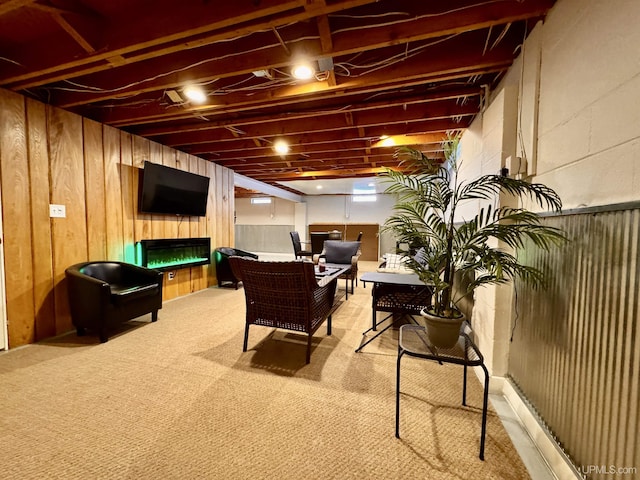 game room featuring light carpet and wooden walls