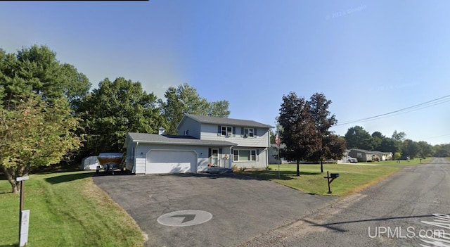 front of property featuring a front yard and a garage