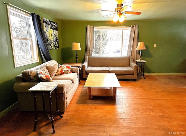 living room with plenty of natural light, ceiling fan, and light hardwood / wood-style flooring