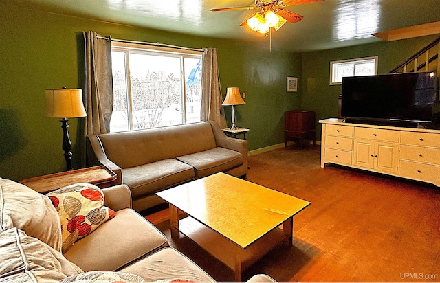 living room with ceiling fan and dark wood-type flooring